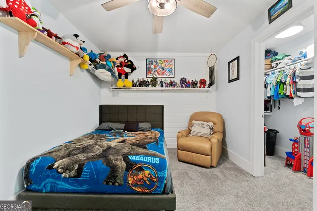 a view of a swimming pool with a small yard and large trees