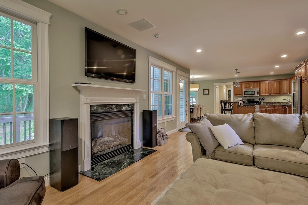 5 Wilkes Road Rowley, MA 01969 - Photo 11 of 25 a living room with furniture a fireplace and a flat screen tv