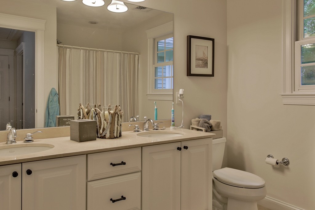 5 Wilkes Road Rowley, MA 01969 - Photo 16 of 25 a bathroom with a granite countertop sink a toilet and a mirror
