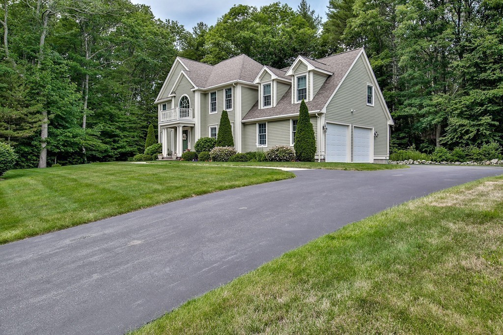 5 Wilkes Road Rowley, MA 01969 - Photo 25 of 25 a front view of a house with a yard and garage