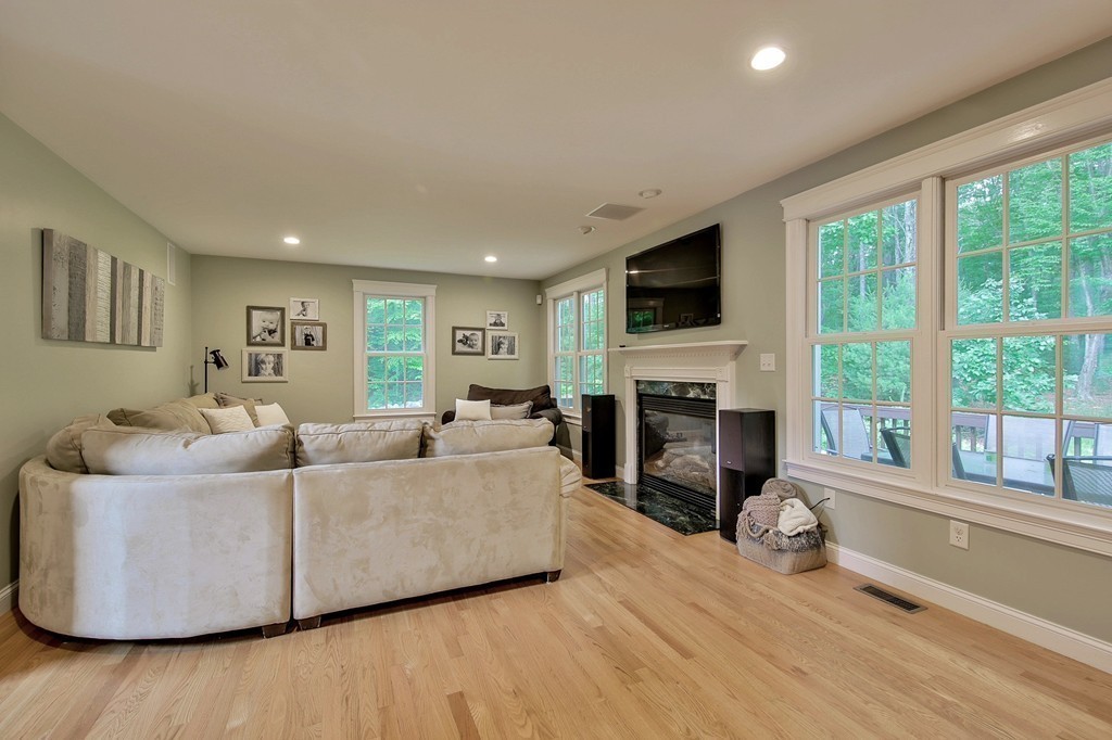 5 Wilkes Road Rowley, MA 01969 - Photo 10 of 25 a living room with furniture a fireplace and a flat screen tv
