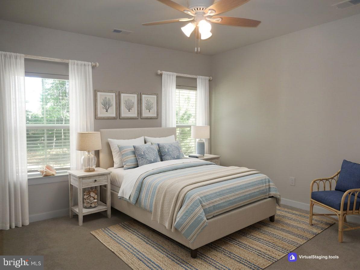 36884 Red Cedar Loop Ocean View, DE 19970 - Photo 26 of 50 a bedroom with a bed and a chandelier