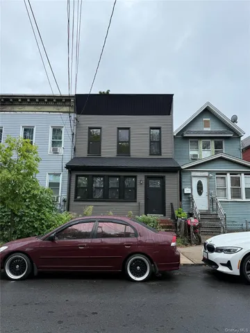a front view of a house with parking space