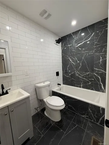 a bathroom with a toilet sink and shower