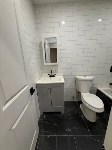 a bathroom with a toilet and sink