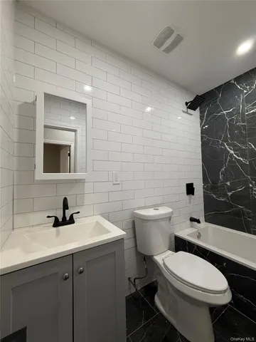 a bathroom with a sink toilet a mirror and shower