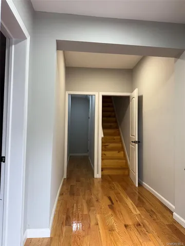 a view of a hallway with wooden floor and entryway
