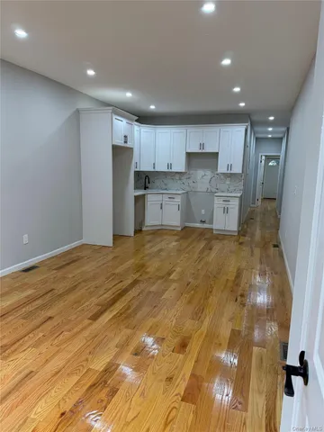 a large kitchen with kitchen island a sink stainless steel appliances and cabinets