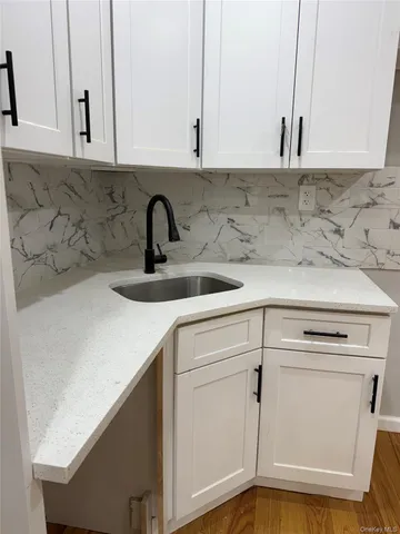 a kitchen with a sink and cabinets