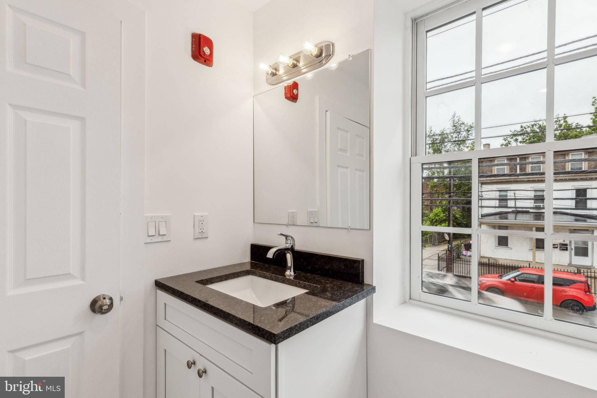 7039 Ridge Avenue Philadelphia, PA 19128 - Photo 21 of 26 a bathroom with a sink and a window
