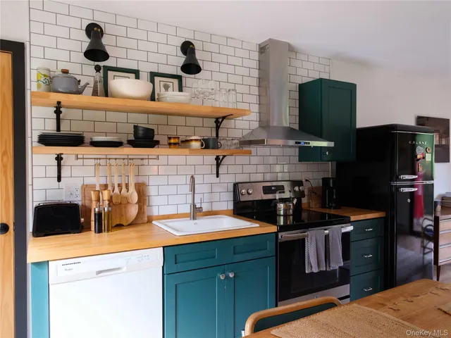 a kitchen with stainless steel appliances kitchen island granite countertop a refrigerator and a stove