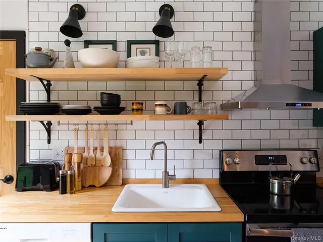 a kitchen with kitchen island a stove and a sink