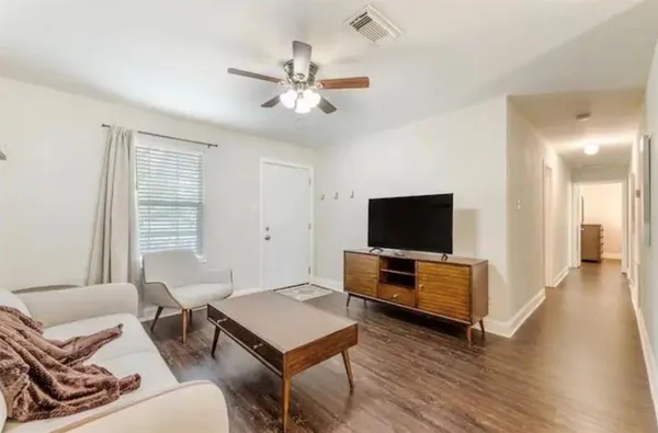a living room with furniture and a flat screen tv