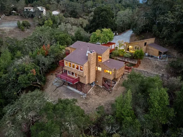 an aerial view of a house with a yard