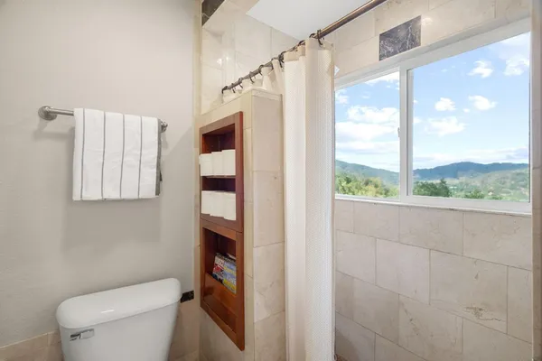 a bathroom with a toilet and a shower