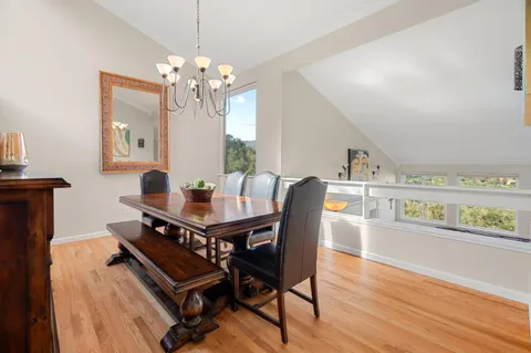 a view of a dining room with furniture and chandelier