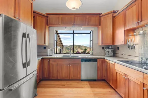 a kitchen with stainless steel appliances granite countertop a refrigerator and a sink
