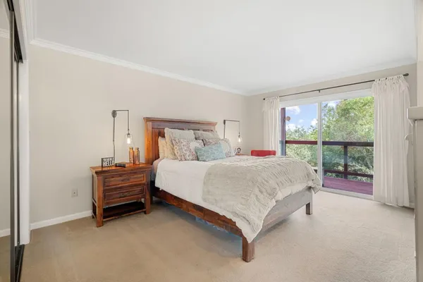 a bed sitting in a bedroom next to a window