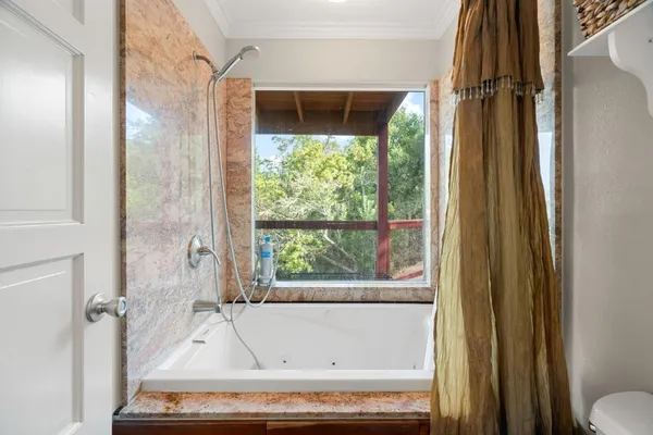a bathroom with a tub and a shower