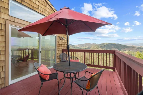 a view of a chairs and table in the balcony