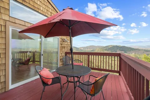 a view of a chairs and table in the balcony