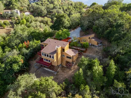 an aerial view of a house with a yard swimming pool outdoor seating