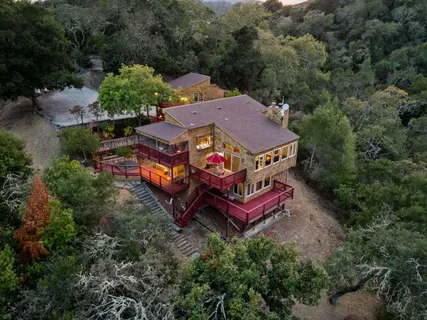 an aerial view of a house with a yard