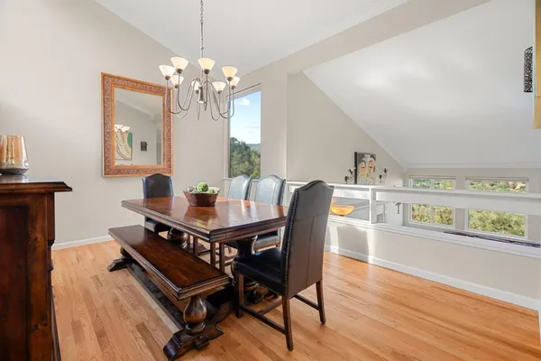 a view of a dining room with furniture and chandelier
