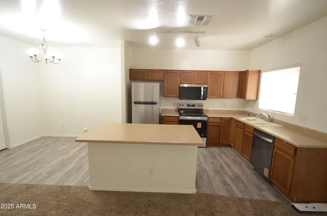 a large kitchen with cabinets and stainless steel appliances