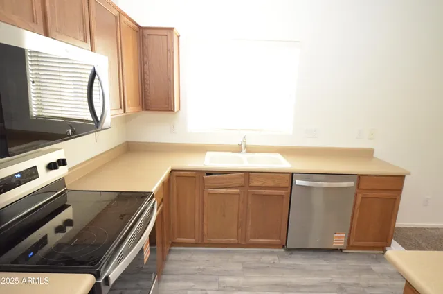 a view of a kitchen with a sink and dishwasher