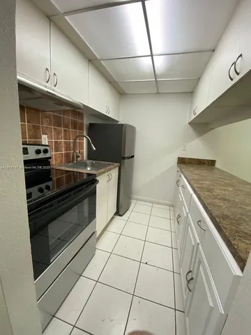 a kitchen with a stove and a microwave