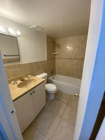 a bathroom with a sink a toilet and a shower