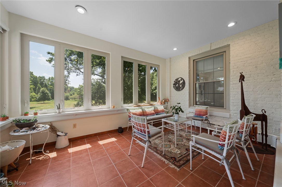 12546 Cedar Road, Unit 4 Cleveland Heights, OH 44106 - Photo 13 of 43 Spectacular 4 season sunroom with ceramic tile floor that overlooks a 2-acre park like area with a patio and lily pond, perfect for alfresco dining and cookouts.