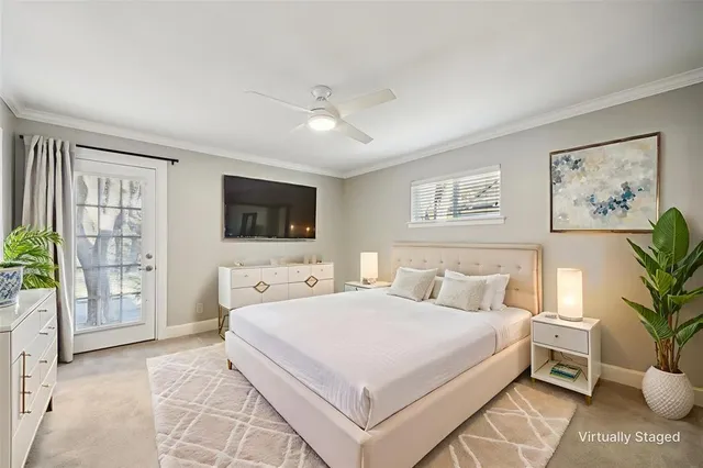 a bedroom with a large bed and a flat screen tv