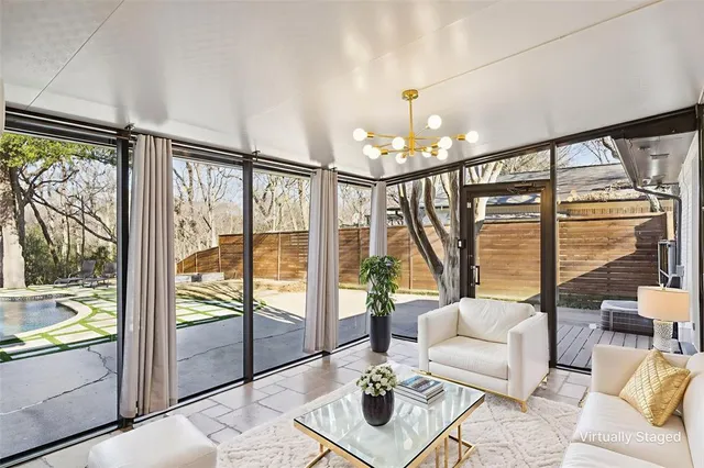 a living room with furniture and a floor to ceiling window