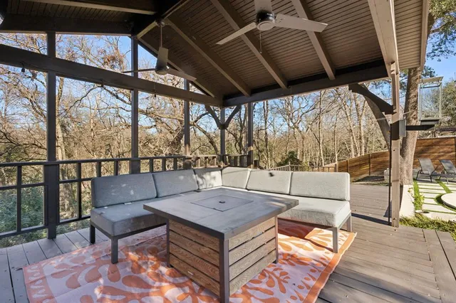 a living room with furniture and a floor to ceiling window