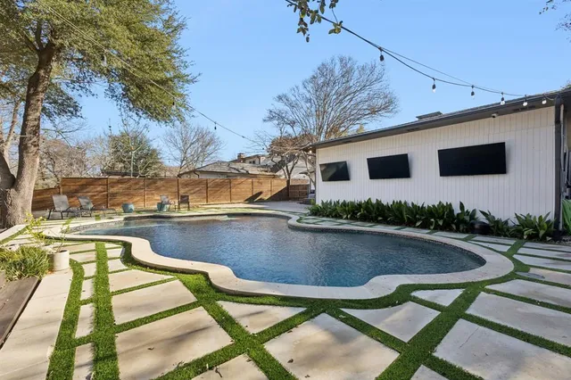 a view of swimming pool with outdoor seating and yard