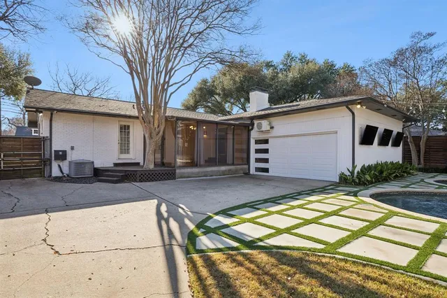 a view of house with backyard and trees