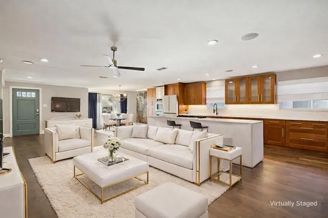 a living room with furniture and kitchen view