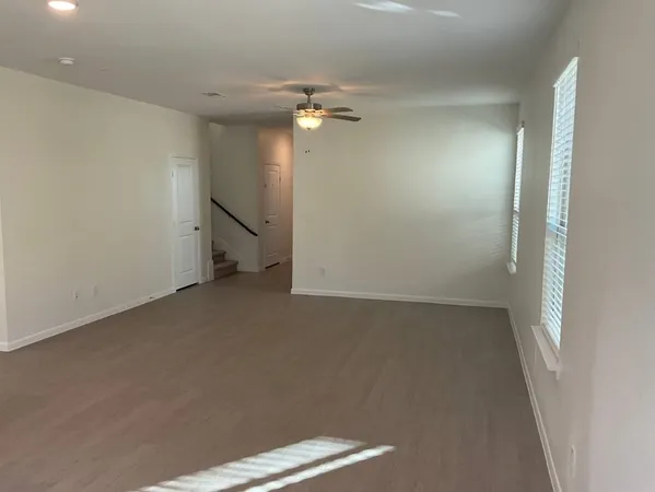 a kitchen with stainless steel appliances granite countertop a refrigerator a stove a sink and white cabinets