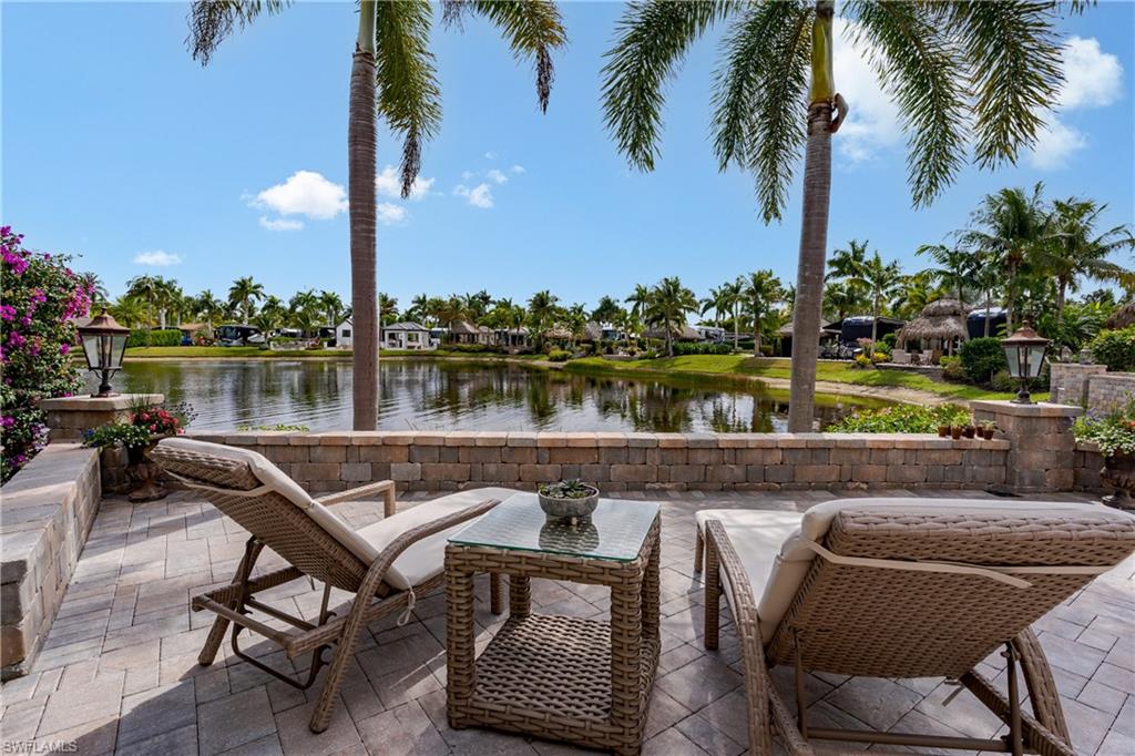 13410 Snook Circle Naples, FL 34114 - Photo 1 of 50 a balcony with furniture and a lake view