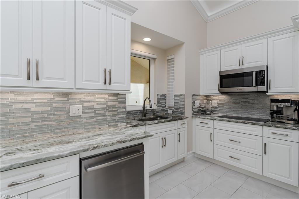 13410 Snook Circle Naples, FL 34114 - Photo 17 of 50 a kitchen with granite countertop white cabinets stainless steel appliances and a sink