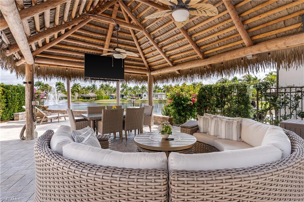 13410 Snook Circle Naples, FL 34114 - Photo 22 of 50 a view of a patio with a table and chairs and potted plants