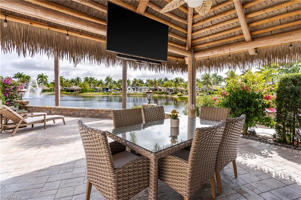 13410 Snook Circle Naples, FL 34114 - Photo 25 of 50 a view of a patio with a table chairs and a patio