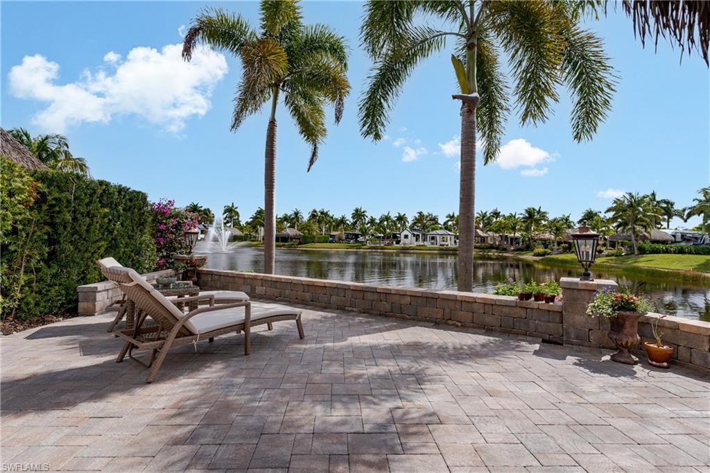 13410 Snook Circle Naples, FL 34114 - Photo 28 of 50 a swimming pool with outdoor seating and lake