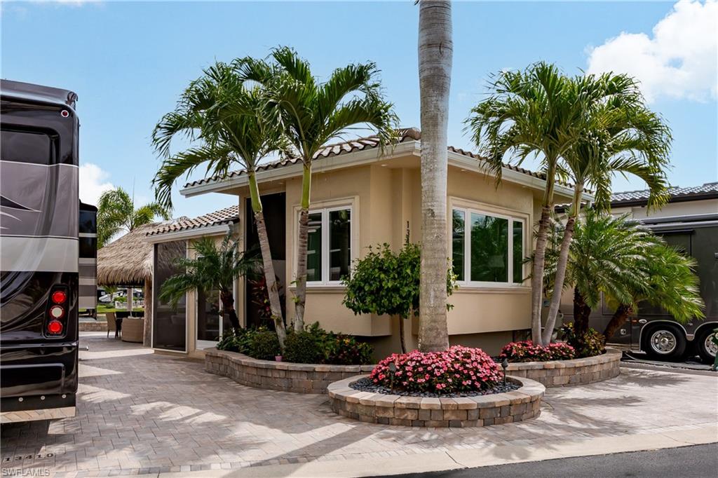 13410 Snook Circle Naples, FL 34114 - Photo 4 of 50 a front view of a house with a yard