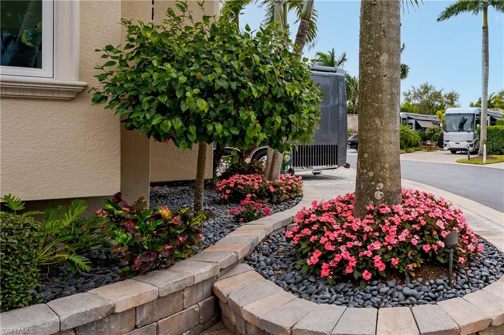 13410 Snook Circle Naples, FL 34114 - Photo 44 of 50 a view of a flower garden with a house in background