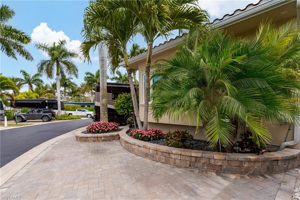 13410 Snook Circle Naples, FL 34114 - Photo 45 of 50 a view of a backyard with a fountain and a plant