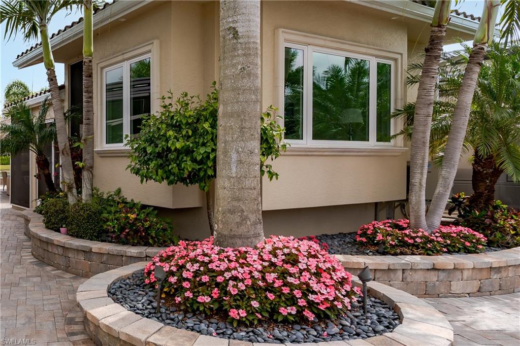 13410 Snook Circle Naples, FL 34114 - Photo 6 of 50 a view of a wooden house with a flower garden