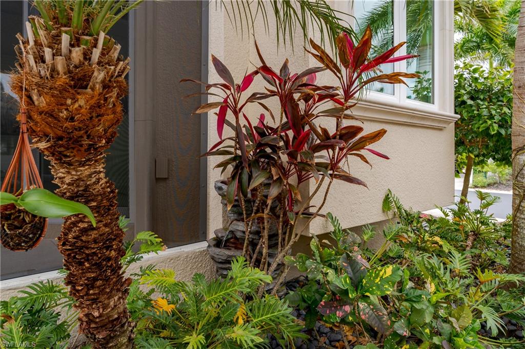 13410 Snook Circle Naples, FL 34114 - Photo 8 of 50 a view of a potted plant with sign and a flower plant